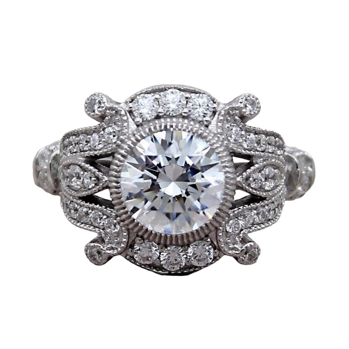 Isolated top-down view of round cut lab diamond engagement ring with vintage filigree shoulders.