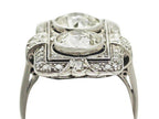 Low-angle side view of vintage Art Deco two-stone lab diamond plaque ring showing raised bezels and milgrain edging.