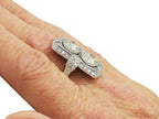 On-hand angled view highlighting the vertical two-stone layout and micro-pavé borders of a vintage lab diamond ring.