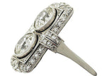 Three-quarter side angle showing slim band transition and micro-pavé shoulders on two-stone Art Deco lab diamond ring.