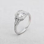 Three-quarter angle shot of 2 CT round lab diamond engagement ring featuring an Art Deco octagonal halo on fabric