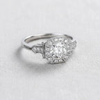 Side profile angle showing milgrain chevron shoulders on a white gold round lab diamond engagement ring.