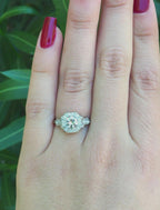 Top-down view on hand displaying finger coverage of an octagonal halo 2 CT round lab diamond ring.