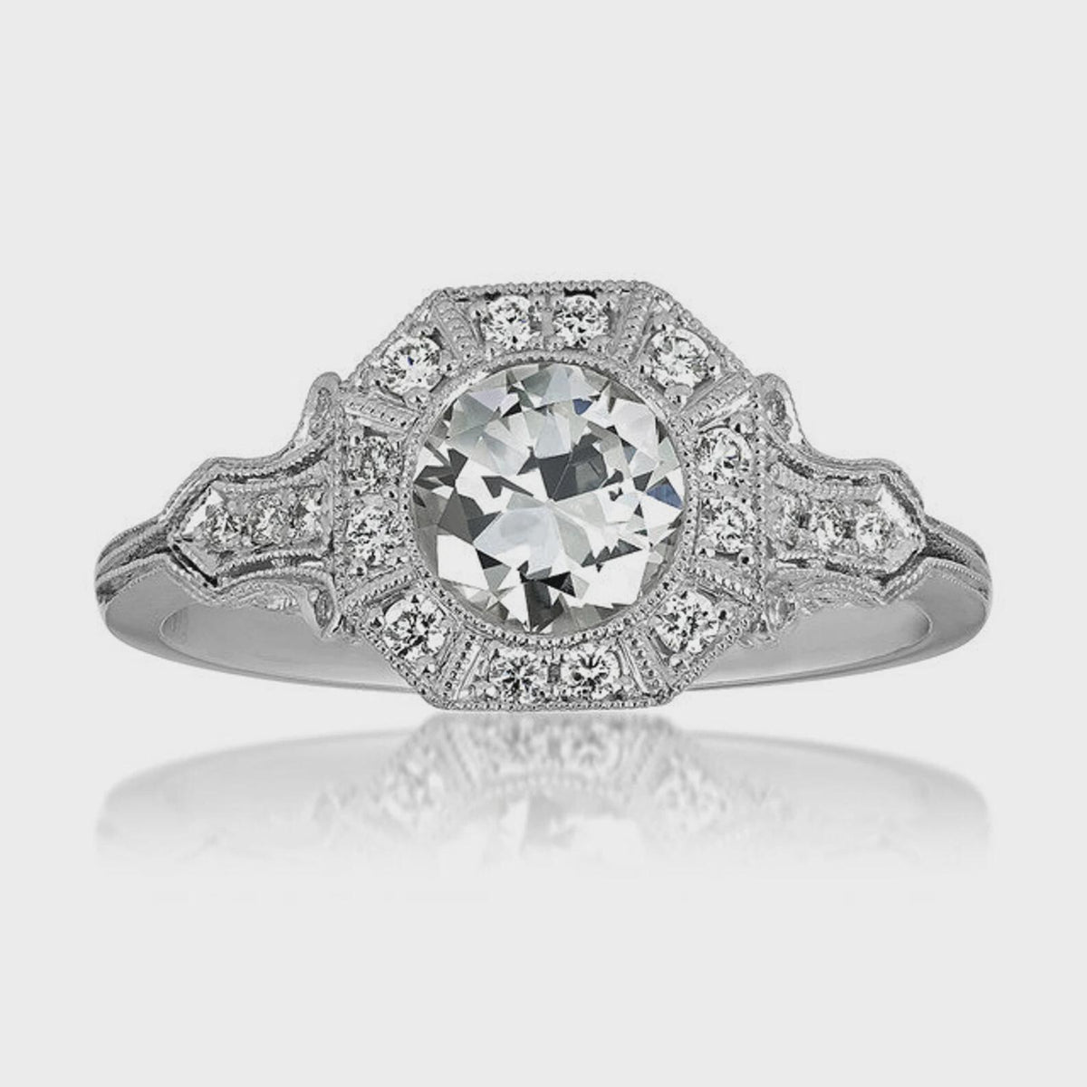Overhead studio shot of 2 CT round cut lab grown diamond ring with octagonal halo and mirror reflection.