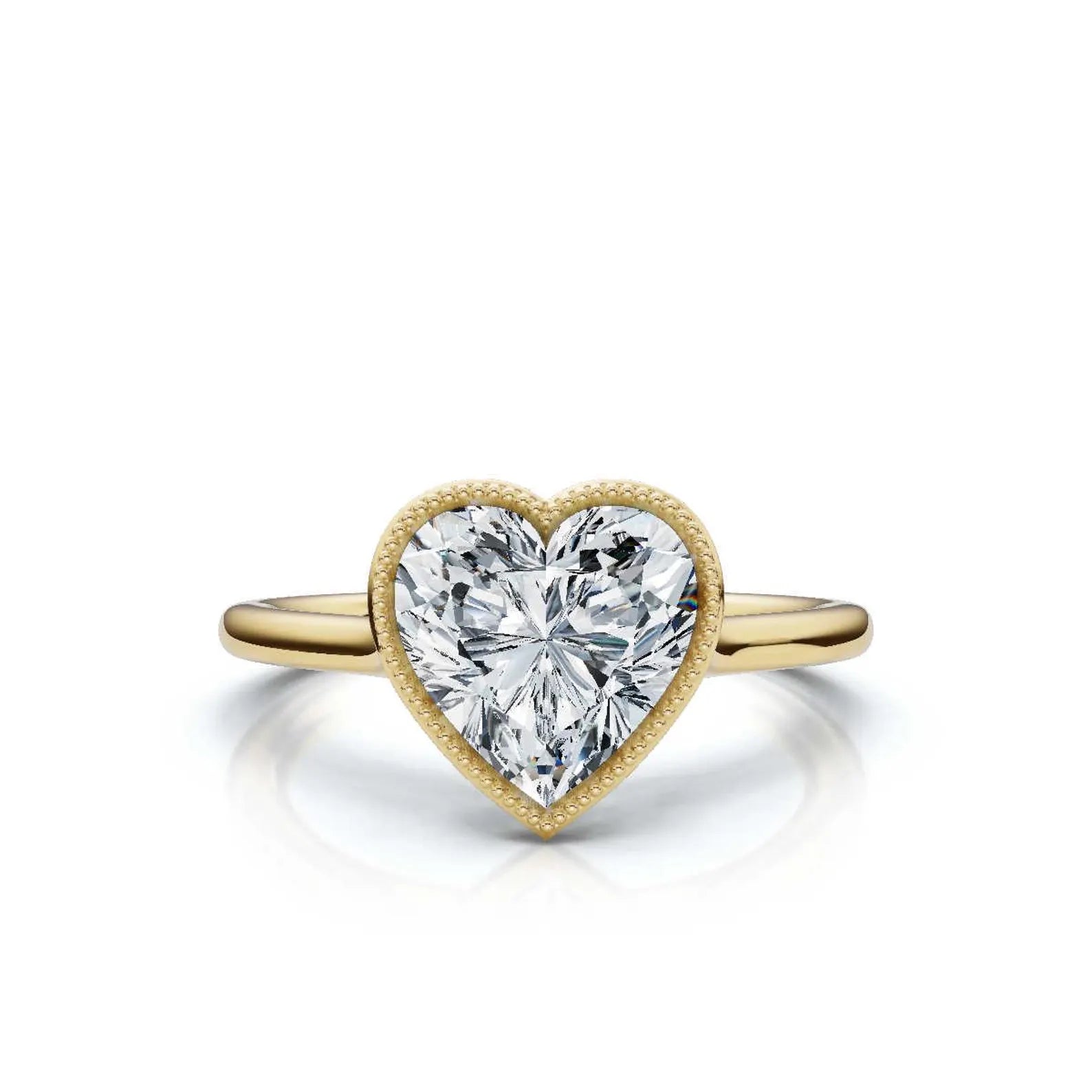 3ct heart-shaped diamond ring featuring a beaded milgrain bezel and polished yellow gold band on a clean white background.