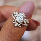 On-finger view of 2 CT oval lab diamond halo ring stacked with matching tiara crown wedding band.
