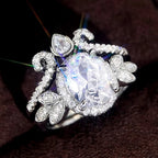 Studio macro view on dark background highlighting sparkle of 2 CT oval lab diamond ring set.