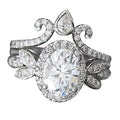 Macro front view showing interlocking 2 CT oval engagement ring and crown tiara band.