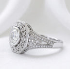 Side profile of a 2 carat round lab-grown diamond bezel ring featuring milgrain detailing and split-shoulder pavé diamonds.