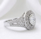 Perspective angle showing the octagonal halo framing a 2 CT round lab diamond with filigree and shoulder side stones.