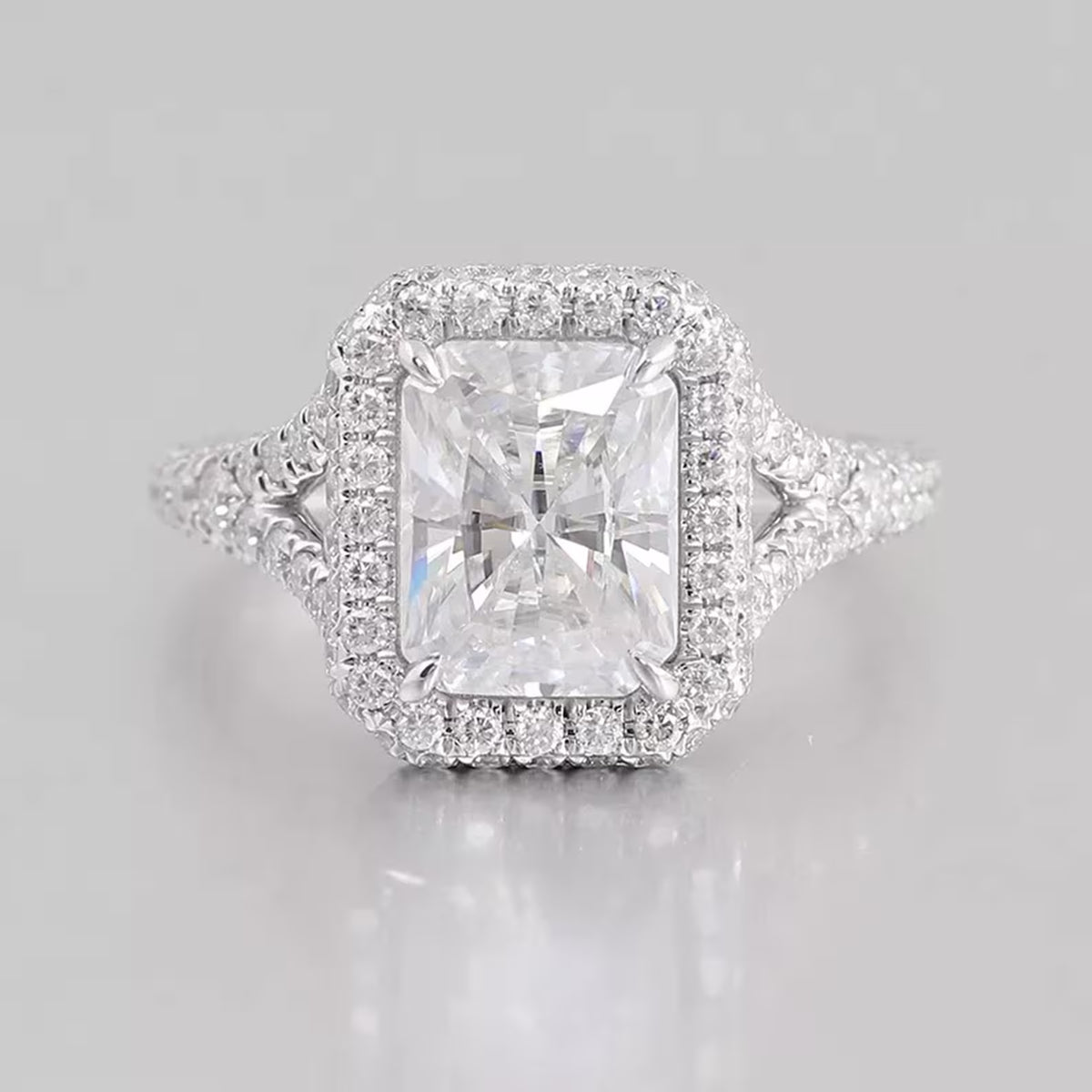 Top-down view of a 3 CT radiant cut lab-grown diamond ring with a diamond halo and split-shank pavé band