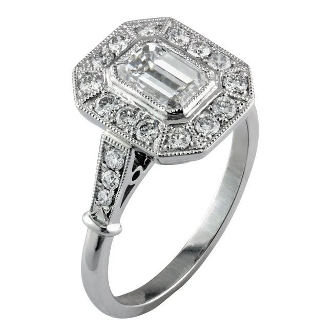 Perspective view of a 2 CT emerald cut lab-grown diamond engagement ring with an Art Deco octagonal halo and milgrain shoulders.