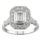 Front view of a 2 carat emerald cut lab diamond ring featuring an inner bezel and vintage octagonal milgrain halo.