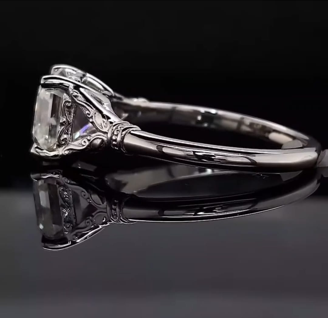 Side profile view of a 3 CT Asscher cut lab grown diamond ring with intricate vintage scrollwork basket on a reflective background.