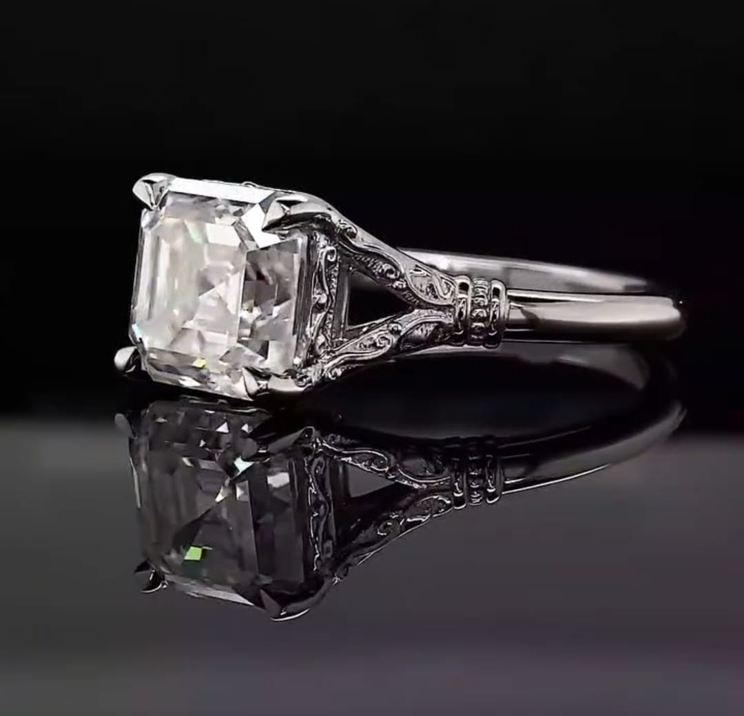Angled view displaying the step-cut clarity and filigree split-shoulder setting of a 3 CT Asscher cut lab diamond ring.
