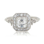 Front top-down view of 2 CT Asscher cut lab grown diamond ring featuring a vintage Art Deco halo and milgrain borders.