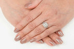 On-hand perspective displaying a 2 carat Asscher cut lab diamond vintage halo engagement ring in white gold.