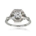 Under-gallery perspective showing the geometric latticework cutout pattern beneath a 2 carat Asscher cut lab diamond halo ring.