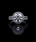 Direct top view of 3 carat round brilliant lab diamond in a micro pavé halo setting with split band.