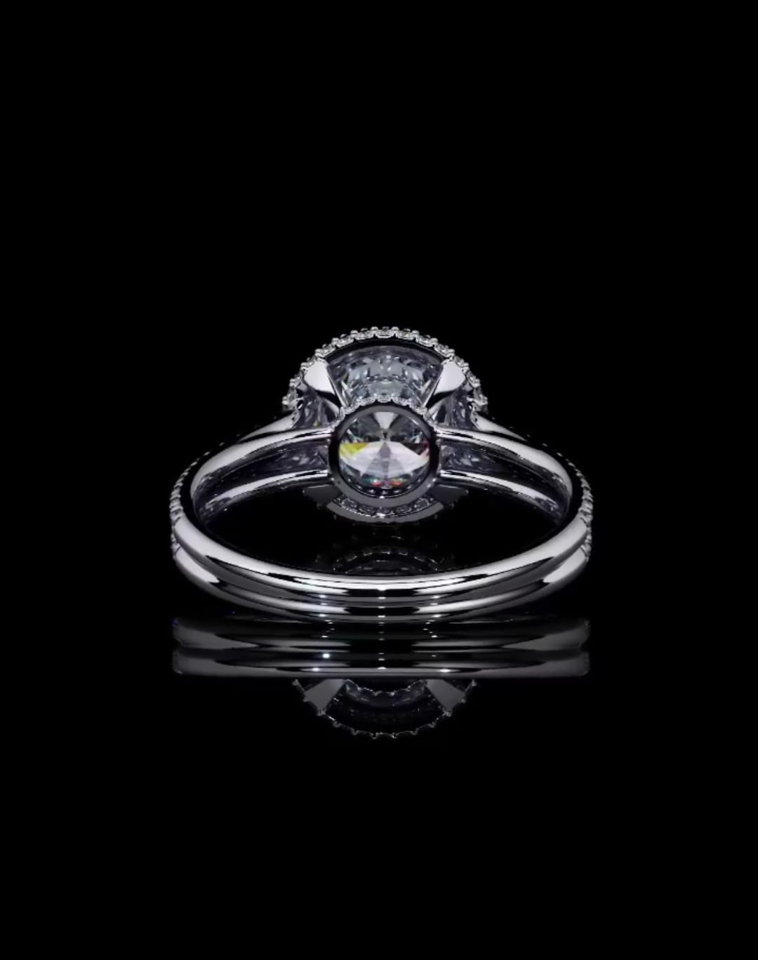 Direct bottom profile showing the open basket and culet setting of a round lab grown diamond halo ring.