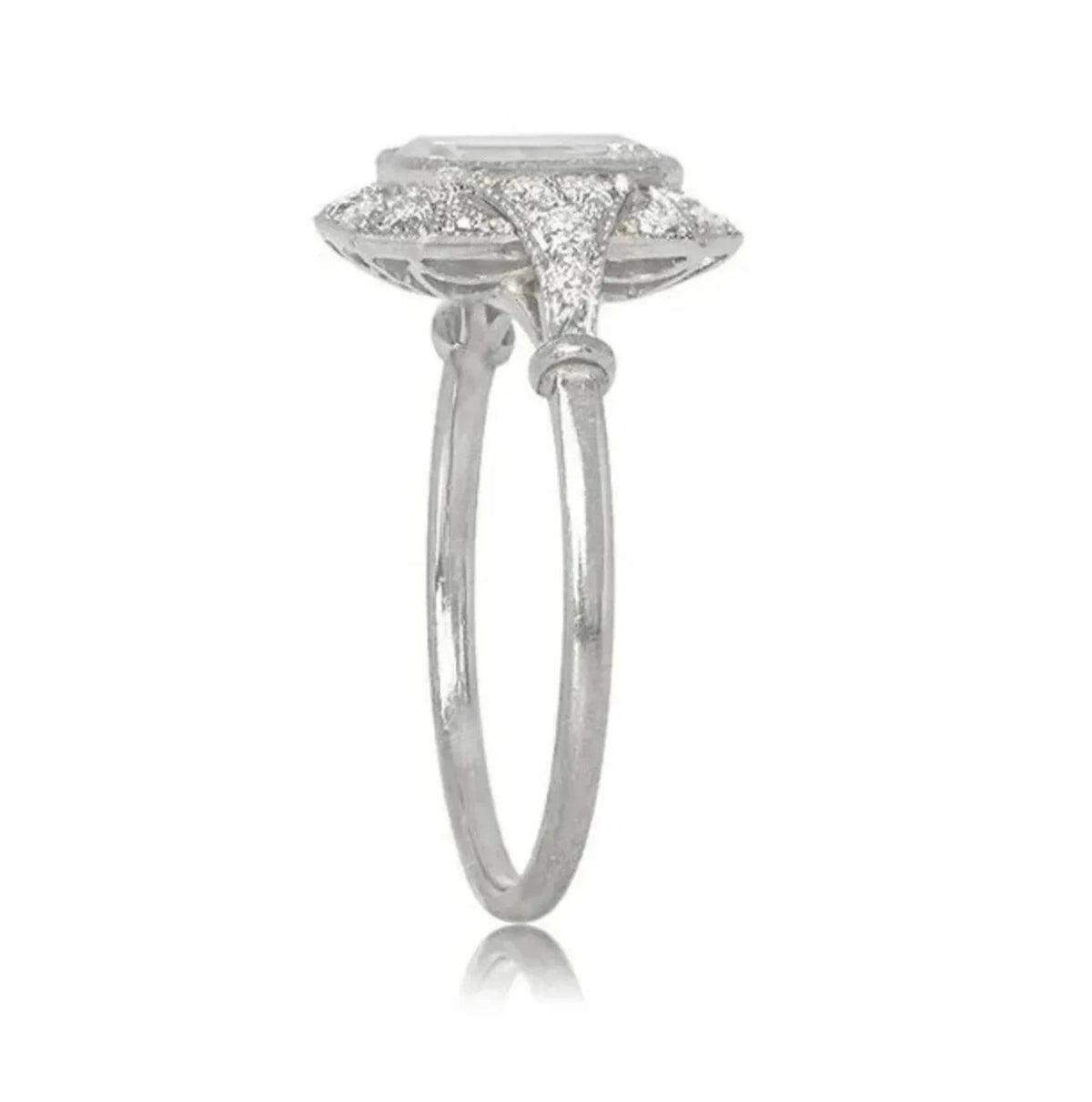 Side profile view of a 2 CT emerald cut lab grown diamond halo ring with pave-set diamond shoulders and milgrain detailing.