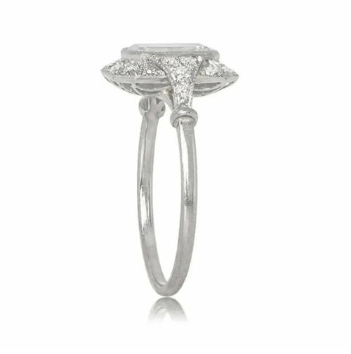 Side profile view of a 2 CT emerald cut lab grown diamond halo ring with pave-set diamond shoulders and milgrain detailing.