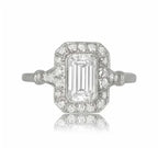 Top-down view of a 2 carat emerald cut lab grown diamond engagement ring with a vintage diamond halo.