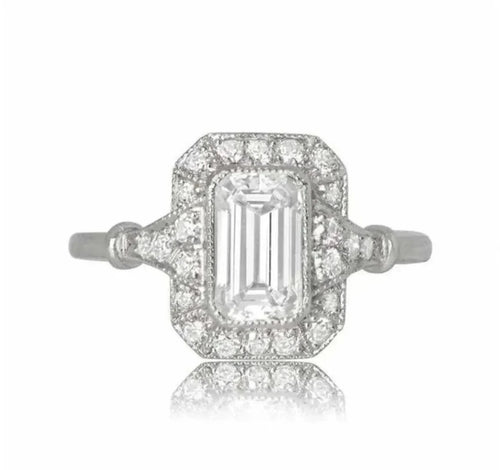 Top-down view of a 2 carat emerald cut lab grown diamond engagement ring with a vintage diamond halo.