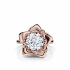 Top-down view of a 3 carat round cut lab grown diamond set inside a rose gold flower petal ring setting.