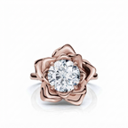 Overhead view of a round brilliant cut lab grown diamond surrounded by rose gold flower petals.