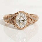 Top view of a 3 CT oval cut lab grown diamond engagement ring in 14K rose gold featuring hand-engraved leaf patterns and fine milgrain detailing.