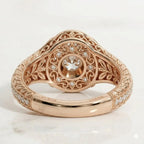 Underside view displaying intricate filigree scrollwork undergallery with a secret diamond halo and 14K Rose gold hallmark stamp.