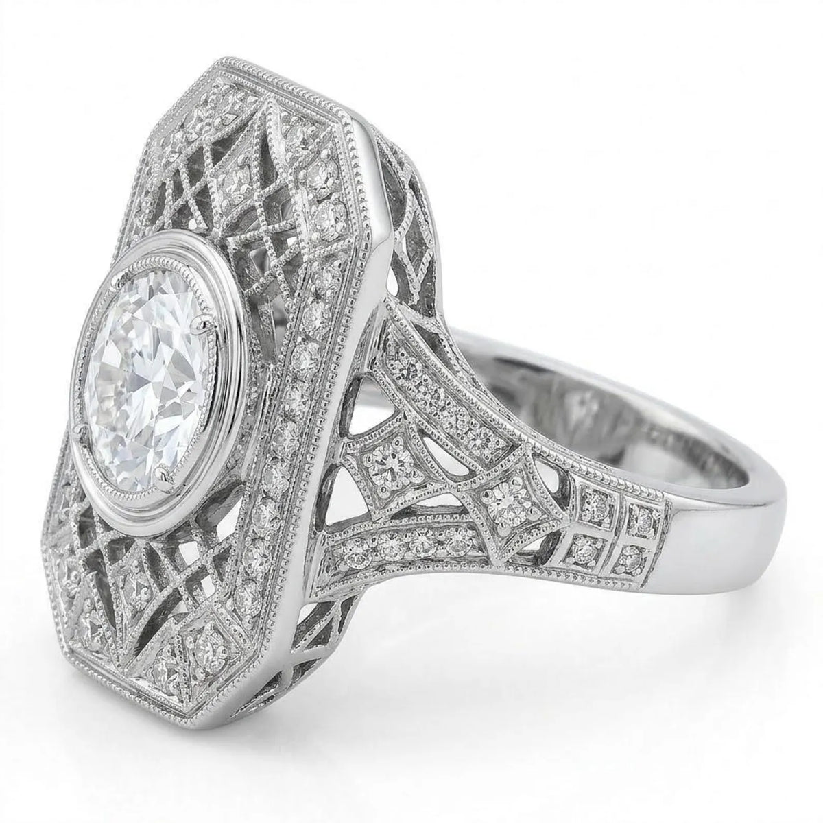 Side angle view of a vintage platinum shield ring showing pave-set diamond shoulders and openwork geometric lattice side walls.