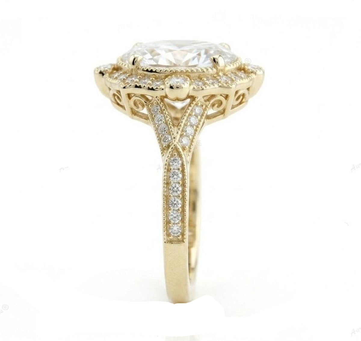 Top-down view of a 3 CT oval cut lab grown diamond engagement ring in yellow gold with a scalloped halo and milgrain split band.