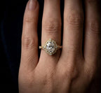 On-hand view of a 3 carat oval lab grown diamond scalloped vintage engagement ring in yellow gold.