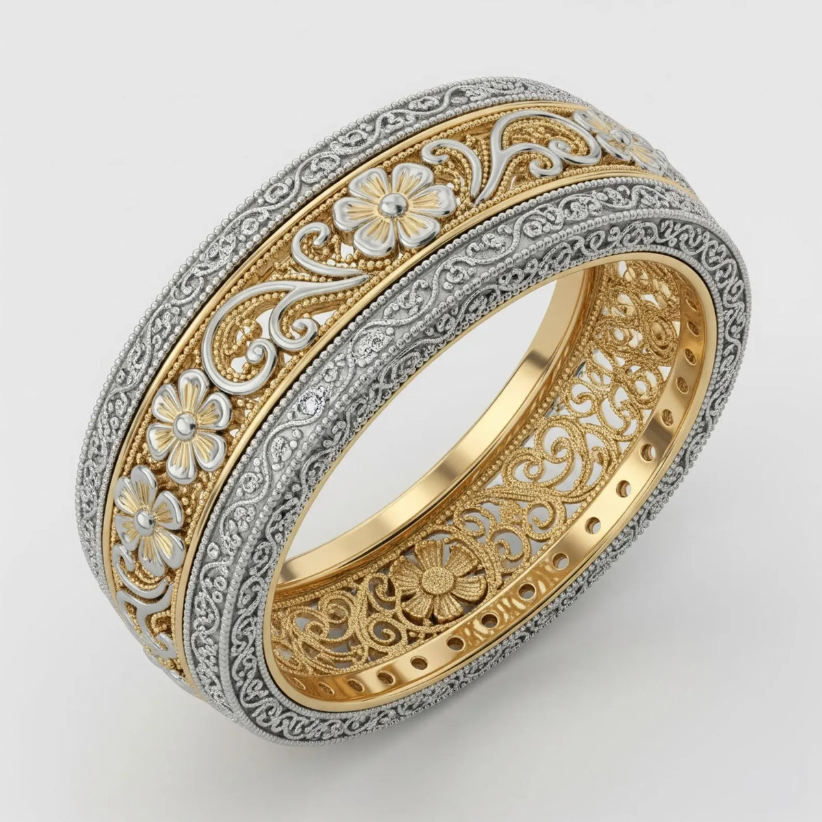 Two-tone vintage floral filigree wedding band showing silver flowers on a gold background with milgrain borders.