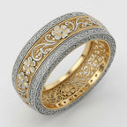Close-up of ornate inner floral gallery cutouts and detailed two-tone filigree scrollwork on a wedding ring.