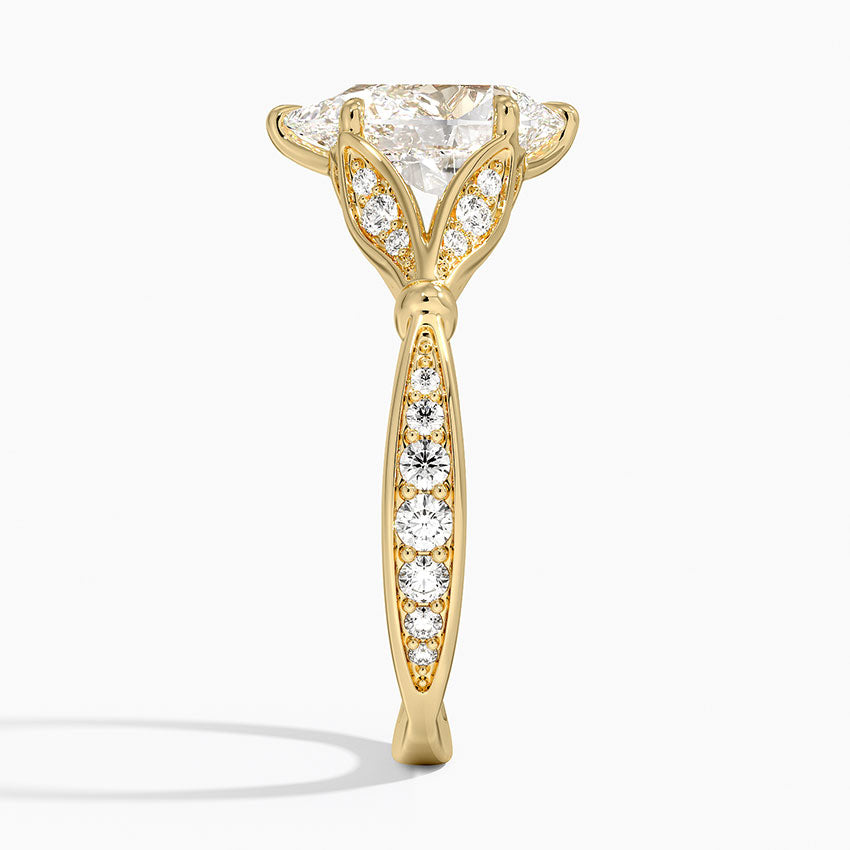 Side view of 2 CT pear cut lab diamond engagement ring in yellow gold showing pave band and diamond-paved petal prongs.