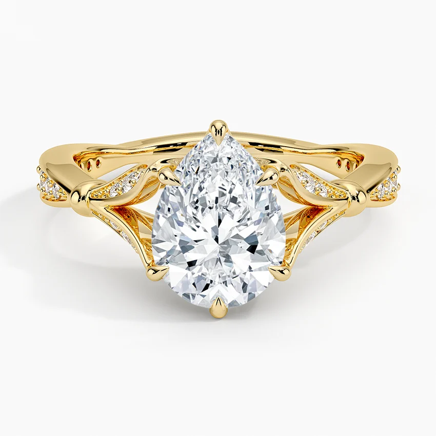 Top-down view of a 2 CT pear cut lab grown diamond set in a yellow gold botanical basket ring.