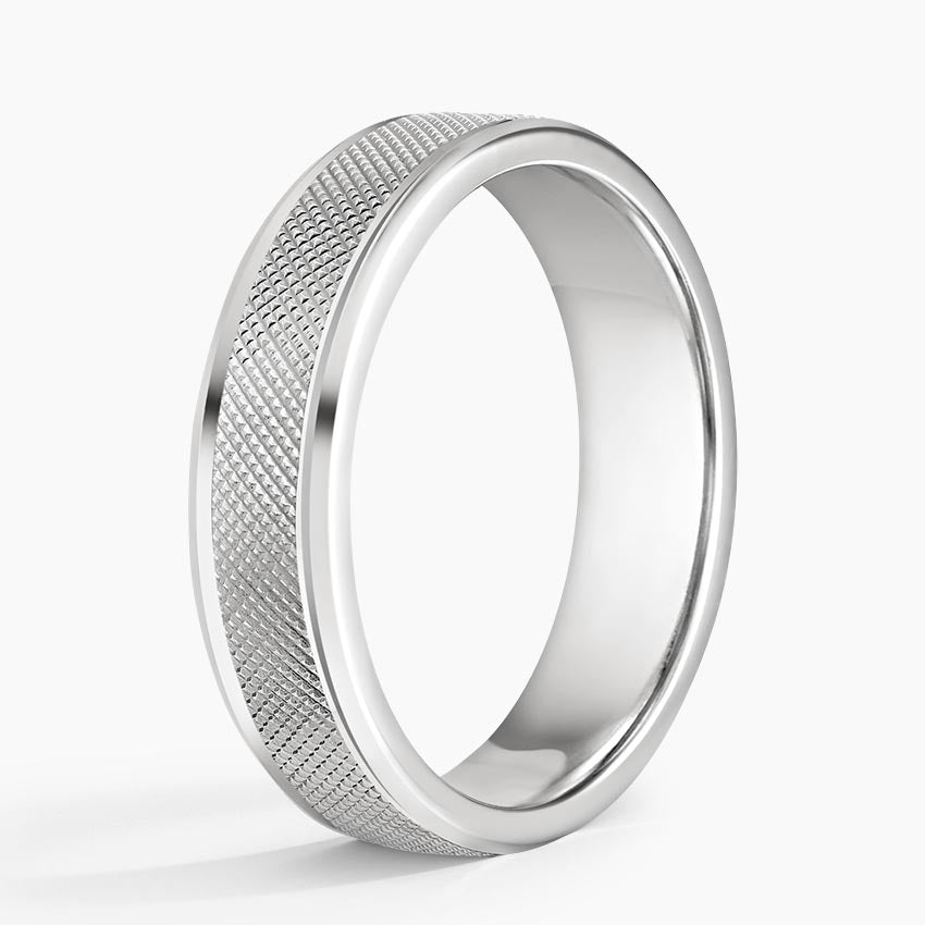 Angled view of white gold men's wedding band with cross-hatch textured center and polished beveled edges.