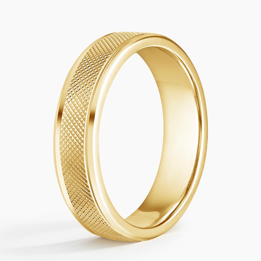 Angled view of yellow gold men's wedding ring displaying cross-hatch texture and bevel borders.