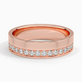 Front profile of rose gold men's wedding ring with an asymmetric line of sparkling diamonds.