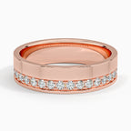 Front profile of rose gold men's wedding ring with an asymmetric line of sparkling diamonds.