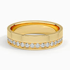 Front view of yellow gold men's wedding band featuring an off-center diamond accent channel.