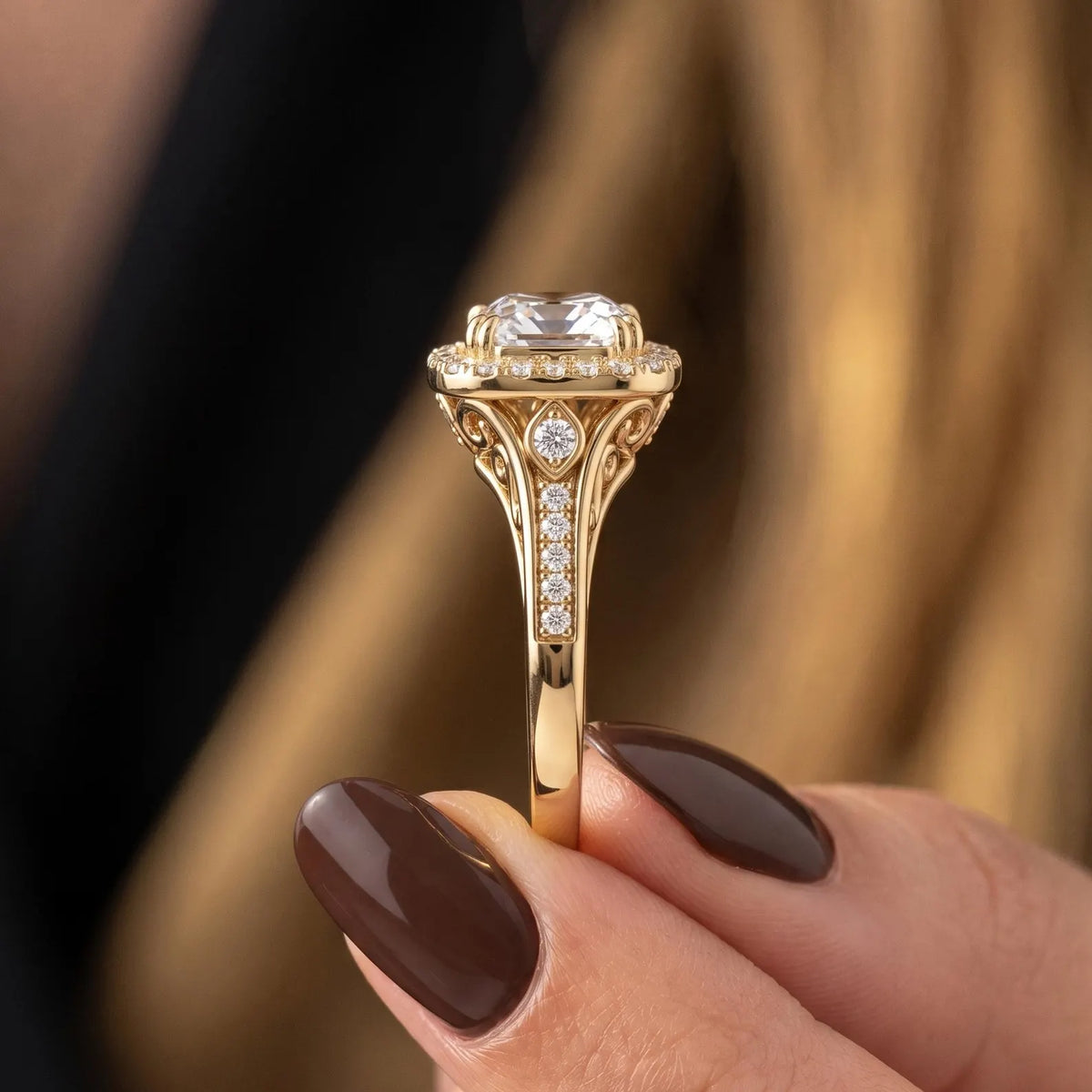 Detail view of split shank pavé band and intricate filigree setting on a yellow gold diamond ring.