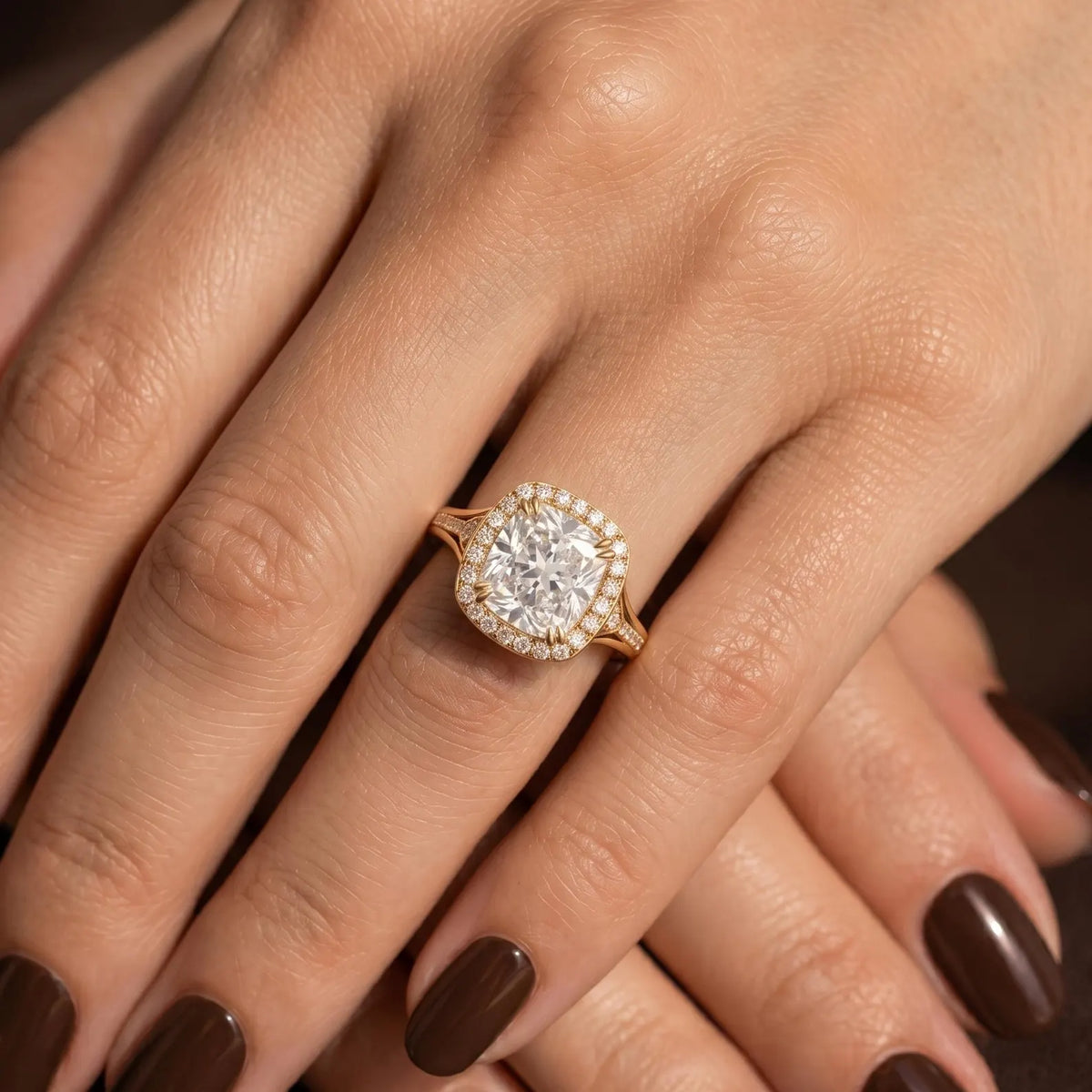 Elegant lifestyle image of 4 ct cushion cut lab grown diamond engagement ring worn on hand.