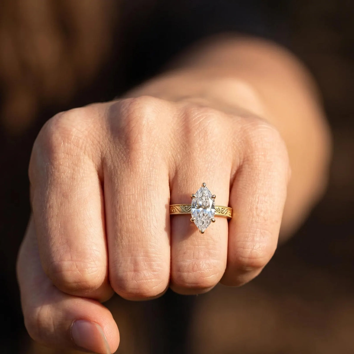 On-hand view of a 3 ct marquise lab diamond engagement ring in 14k yellow gold with vintage detail.