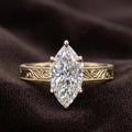 Front view of vintage style 3 ct marquise lab grown diamond ring resting on dark velvet background.