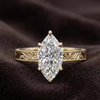 Front view of vintage style 3 ct marquise lab grown diamond ring resting on dark velvet background.