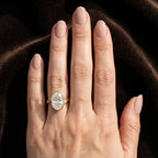 Top down view of 4 carat oval lab diamond ring in bezel setting with bypass shank.
